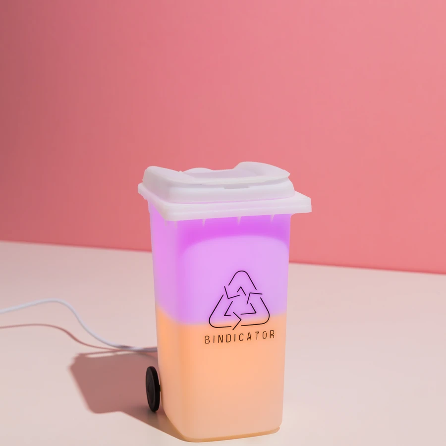 Bindicator lamp glowing in City of Melbourne bin colours on a kitchen shelf